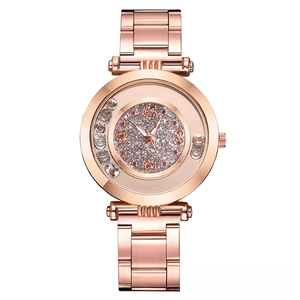 Detail of rose gold watch dial featuring floating crystals and shimmering diamond effect