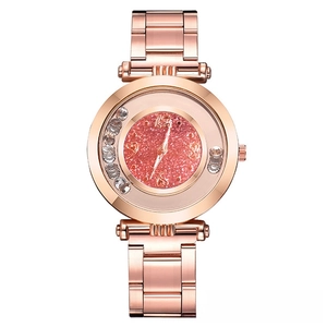 Detail of rose gold quartz watch with pink glitter dial and rhinestone-studded bezel