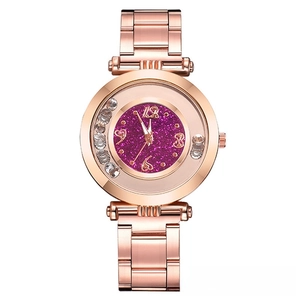 Detail of rose gold watch featuring purple glitter dial and floating crystal diamonds