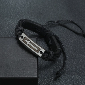 Braided black leather bracelet with metal cross plate on a premium jewelry box