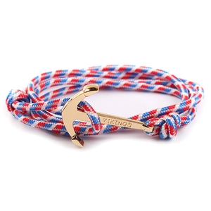 Detail of red white and blue nylon rope bracelet with golden metal anchor clasp engraved VIKINGS