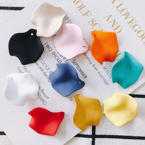 Macro shot of colorful matte petal pendants for DIY jewelry making and earring design