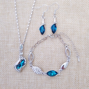 Detailed view of silver crystal jewelry set with blue leaf gems and clear stones