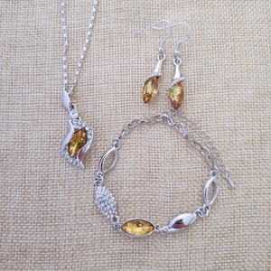 Detailed set of silver necklace, earrings, and bracelet with amber marquise crystals