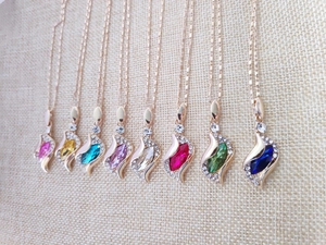 Collection of angel crystal necklaces in eight colors with gold chains and marquise stones