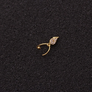 Golden stainless steel wing cartilage earring with sparkling zircon on dark foam