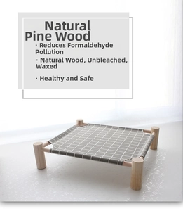 Detail of the natural pine wood frame and gray checkered fabric of the pet hammock bed