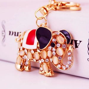Golden elephant keychain with opal stone and rhinestones, perfect for handbags and car keys