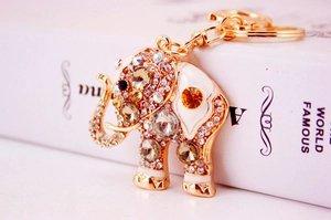 Detailed view of a gold-plated elephant keychain with sparkling crystals and enamel