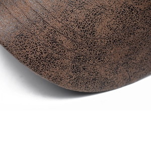 Detail of vintage brown baseball cap brim with multi-row stitching and distressed texture