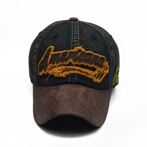 Detailed macro view of American embroidery on a vintage distressed denim baseball cap
