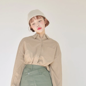 Women's warm beige knit beanie with khaki shirt and green skirt set for winter