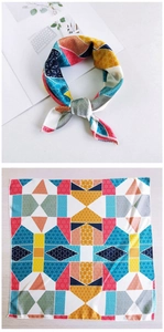 Detail of silk scarf showing colorful geometric patchwork and styled necktie knot