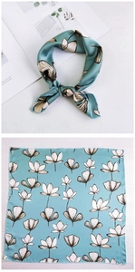 Close-up of blue floral silk square scarf with white and black patterns shown folded