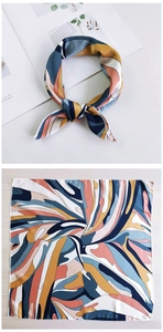 Detail of silk square scarf showing knotted style and full abstract swirl pattern print