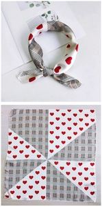 Detail of silk square scarf featuring grey plaid and red heart patterns on white fabric