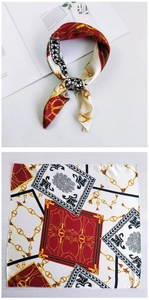 Detail of printed silk scarf with gold chains and red-green stripes for handbag decor
