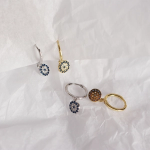 Detailed close-up of gold and silver S925 sterling silver evil eye hoop earrings