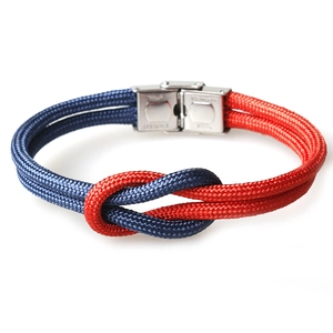 Blue and red paracord rope bracelet with a stainless steel buckle on a white background