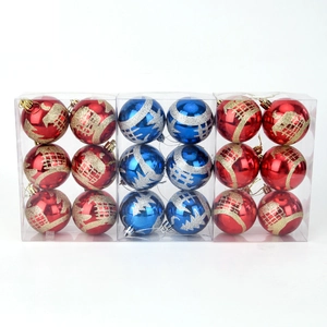 Detailed view of red and blue Christmas balls with glitter patterns in boxed sets