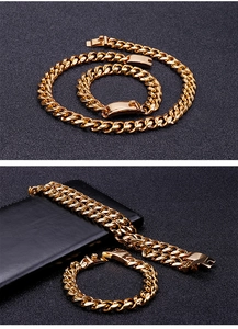 Detail view of golden Cuban link chain set featuring necklace and bracelet with clasp