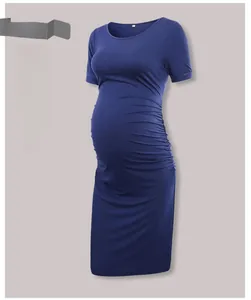 Detail view of the side-ruched design on a navy blue short sleeve maternity dress
