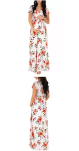 Detail showing high waist elastic band and colorful floral pattern on a V-neck maxi dress