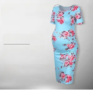 Detail view of light blue maternity dress with large pink rose prints and side ruffles