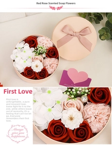 Close-up of red soap flower gift box with roses, carnations and a pink velvet ribbon bow