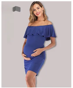 Detail of off-shoulder maternity dress featuring elegant ruffle neckline and side ruching