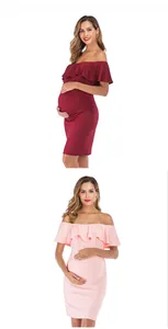 Detail of off-shoulder maternity dress featuring ruffled neckline and side ruching design