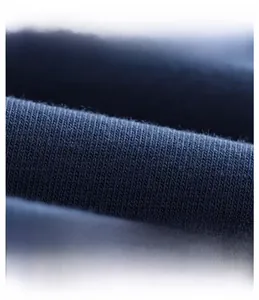 Macro detail of breathable dark blue knit fabric with soft texture and twill weave