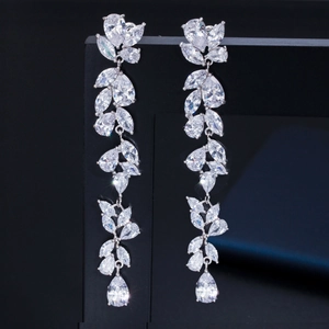 Elegant long leaf and teardrop zircon earrings in silver metal on black display