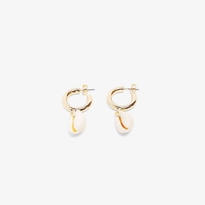 Detail showing golden hoop earrings with white natural shell pendants in ocean style