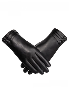 Detail of black faux leather winter gloves with decorative buttons and wrist pleats
