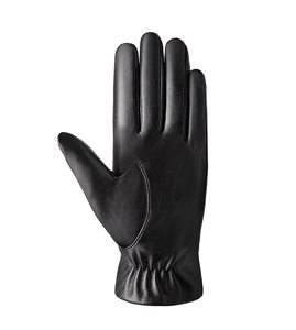 Close-up of black PU leather gloves with elastic cuffs and textured pebble grain detail