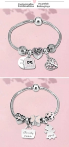 Detailed view of DIY silver snake bone bracelets with heart charms and pink enamel pendants