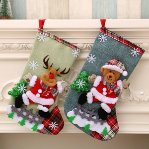 Linen Christmas stockings with reindeer and bear dolls, hanging by a fireplace