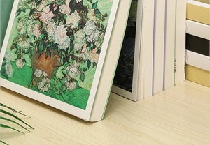 Artistic sketchbook featuring Van Gogh's Pink Roses oil painting cover on wooden table