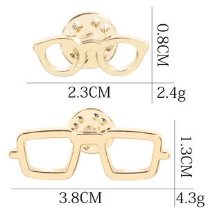 Golden eyewear brooches with dimensions and weight details on a white background