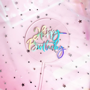 Holographic acrylic Happy Birthday cake topper on pink mesh background with glitter stars