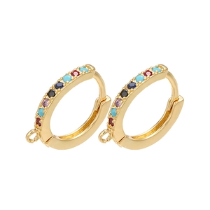 Detail of gold zircon huggie hoops with multi-colored gemstones and hanging attachment