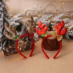 Glitter Christmas reindeer antler headbands with bells and bows on festive background