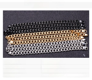 Close-up of three Cuban link chains in gold, black and silver polished stainless steel