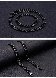 Macro view of black stainless steel Cuban link chain necklace and bracelet set