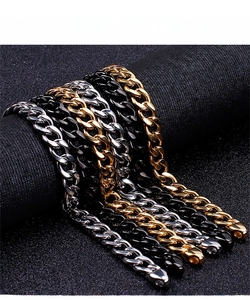 Macro shot of Cuban link chains in gold, silver, and black finish with lobster clasps