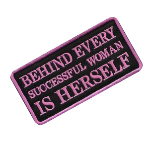 Close-up of rectangle black and pink embroidered patch with motivational quote text