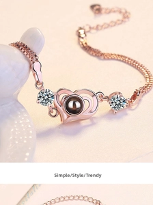 Detailed close-up of rose gold heart bracelet with projection stone and zircon accents