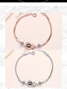Detail of rose gold and silver heart projection bracelets with S925 engraved mesh chains