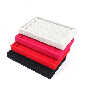 Stack of colorful velvet jewelry trays for rings and earrings display and storage